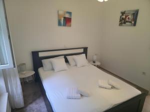 a bedroom with a bed with two towels on it at Apartman deluxe sea in Split +4 photos