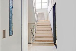 a staircase in a house with wooden steps at Super Collection O Baner Formerly Seven Hills in Pune