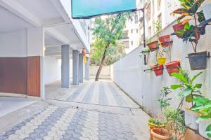 an alley with potted plants on the side of a building at Super Collection O Baner Formerly Seven Hills in Pune