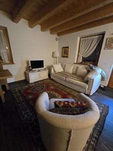 a living room with a couch and a table at Alpine Heaven in Borca di Cadore