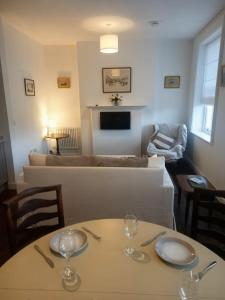 a living room with a table with two wine glasses on it at Clubhouse, North End, Bedale DL8 1AB in Bedale