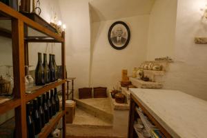 a room with a bunch of wine bottles on a shelf at Villa Cristani in Pedemonte