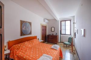 a bedroom with an orange bed and a desk at Villa Cristani in Pedemonte