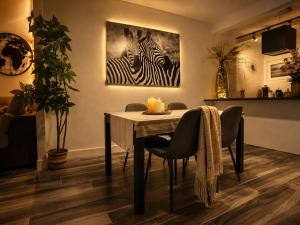 a dining room with a table and two zebras at Ocean Eleven Boutique Stay - Sea View Sunset Terrace in Sainte-Anne