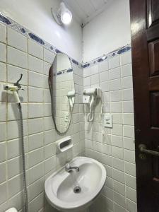 a bathroom with a sink and a mirror at Casa Exclusiva Centro Búzios in Búzios