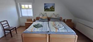 a bedroom with a bed with two pillows on it at Haus Biber - altersgerechtes Ferienhaus am Niederrhein - in Sonsbeck