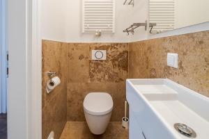 a bathroom with a toilet and a sink and a tub at Alte Schule Reichenau an der Rax in Reichenau +91 photos