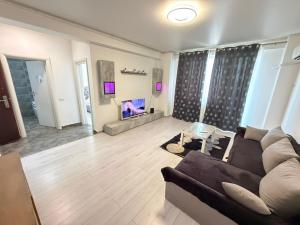 a living room with a couch and a fireplace at R&C Relax Apartment 808 in Dudu