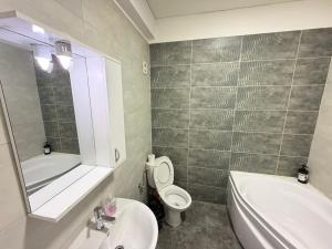 a bathroom with a sink and a toilet and a bath tub at R&C Relax Apartment 808 in Dudu +9 photos