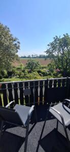 a couple of chairs sitting on top of a balcony at Haus Biber - altersgerechtes Ferienhaus am Niederrhein - in Sonsbeck +19 photos