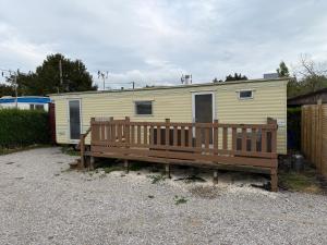 a mobile home with a bench in front of it at Mobilhomme in Brêmes
