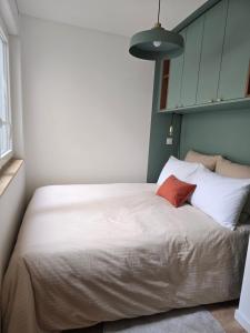 a bedroom with a large bed with two pillows at Lanabi - Studio Cocon in Salies-de-Béarn