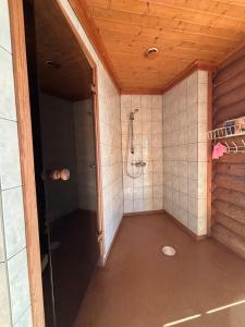 an empty bathroom with a shower in a room at Kalliorinteen Mökit Lehtipirtti in Töysä +5 photos