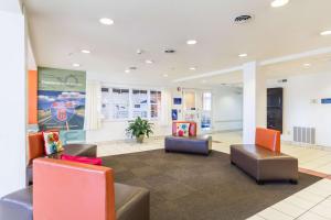 a lobby with couches and chairs in a building at Motel 6-Huron, OH - Sandusky in Huron