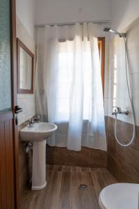 a bathroom with a sink and a shower at Hotel Demaj in Berat +70 photos