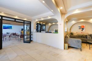 a lobby with a couch and a table and chairs at Casa Lume in Bodrum City