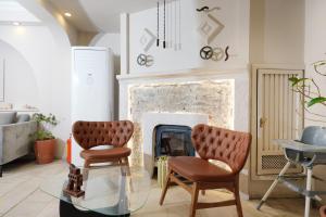 a living room with two chairs and a fireplace at Casa Lume in Bodrum City