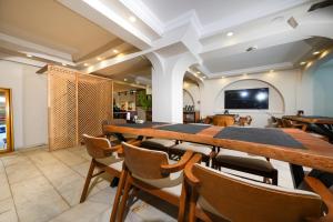a dining room with a long table and chairs at Casa Lume in Bodrum City