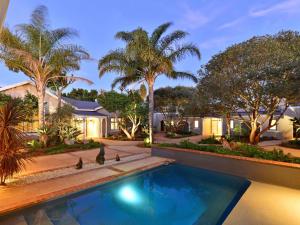 a swimming pool in a home with palm trees at Founders Lodge by Mantis in Paterson