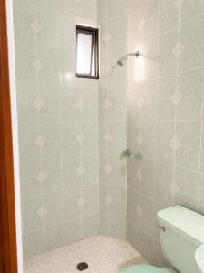 a bathroom with a shower with a toilet at Hotel Bartolomé in Oaxaca City +9 photos
