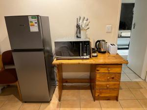 a kitchen with a refrigerator and a microwave at Adorable Pool Side Apartment in Monte Vista