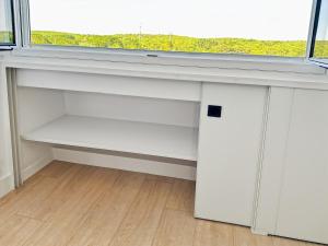 a white desk with a window in a room at Studio entre mer et forêt in Saint-Jean-de-Monts