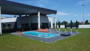 a swimming pool in front of a building at Soccer Box Pro in Dachnów