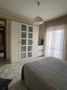 a bedroom with a large bed and a large window at Casa Ada in Termoli
