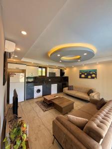 a large living room with a couch and a kitchen at VİLLA Terasa in Fethiye
