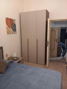 a bedroom with a bed and a large closet at Serenity & Art in Viterbo