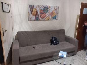 a purse sitting on a couch with a glass table at Serenity & Art in Viterbo