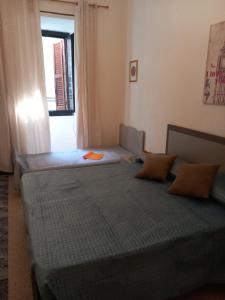 a bedroom with two beds and a window at Serenity & Art in Viterbo
