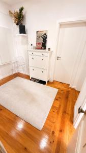a room with a white rug and a white dresser at Avenidas Prime Lisbon in Lisbon