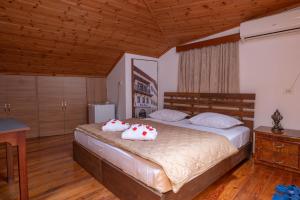 a bedroom with a bed with two pillows on it at Hotel Demaj in Berat