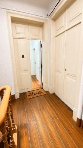 an empty room with two doors and a wooden floor at Avenidas Prime Lisbon in Lisbon