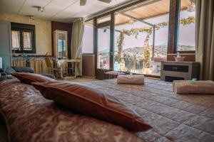 a bedroom with a large bed with pillows on it at Finca Los Pájaros Naturaleza cerca de Puy du Fou in Navahermosa +58 photos