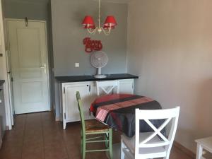 a dining room with a table and two chairs at Location appartement proche Saint Tropez in Roquebrune-sur-Argens