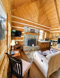a living room with a couch and a fireplace at Copeland Creek- Tiny Cabin in Sevierville