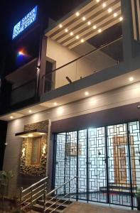 a building with a sign on it at night at Sarva Tranquil home stay in Kumbakonam