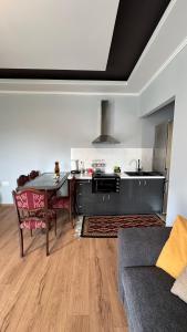 a living room with a table and a kitchen at Αρχοντικό Κάτω Βρύση in Levidi +10 photos