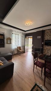 a living room with a couch and a fireplace at Αρχοντικό Κάτω Βρύση in Levidi
