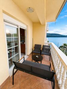 a balcony with chairs and a table and a view of the water at Apartmani Villa Amfora - Free Parking in Neum +37 photos