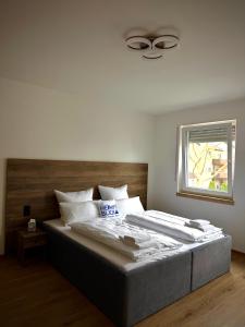 a bedroom with a large bed with a window at Heimatblick Fulda in Fulda