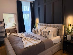 a bedroom with a large bed with a large window at NORDÉA Apartments in Rostock