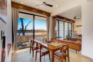 a dining room with a table and chairs and a desk at The Mountain house 4 BHK VIlla With Pool in Rishīkesh