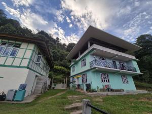 a blue and white house next to a building at Mochilero Nomads in Pelling