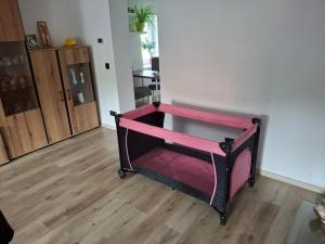 a black and pink bed in a room at Vybavený byt in Krásno