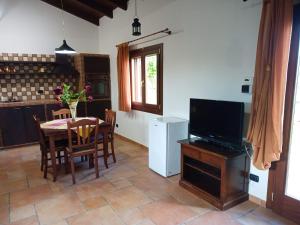 a kitchen and dining room with a table and a television at Momon1616 Intero Chalet in Galatina