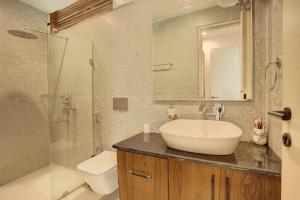 a bathroom with a sink and a shower and a toilet at The Mountain house 4 BHK VIlla With Pool in Rishīkesh