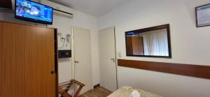 a room with a flat screen tv on the wall at Continental Hotel in Miramar